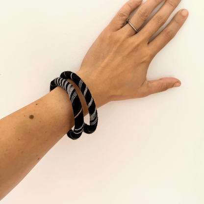 textile bangles in black on hand