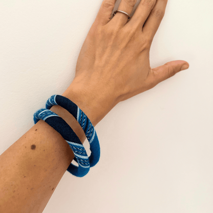 textile bangles in deep blue on hand