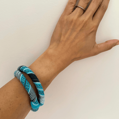 textile bangles in light blue on hand