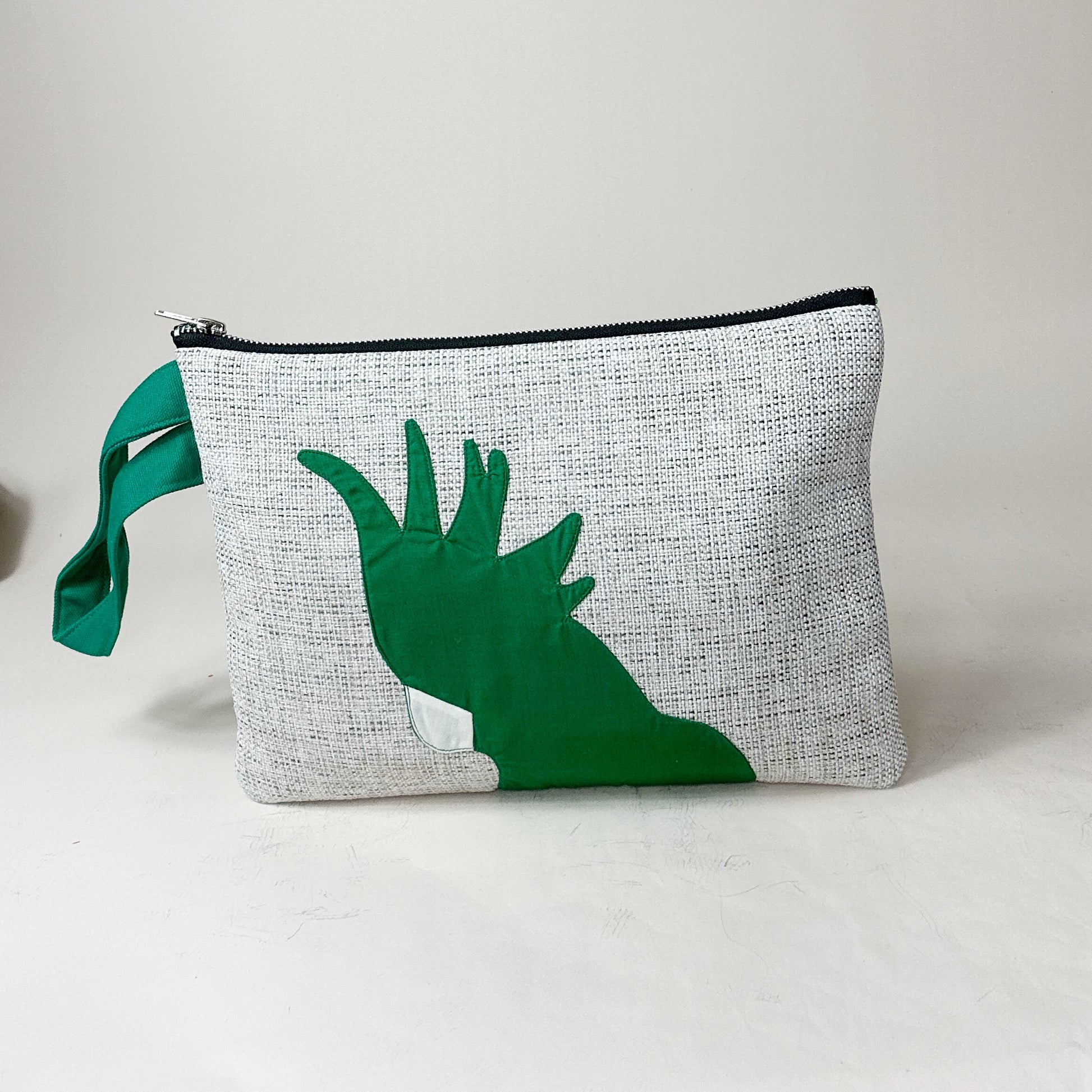 jute cockatoo clutch in green standing up