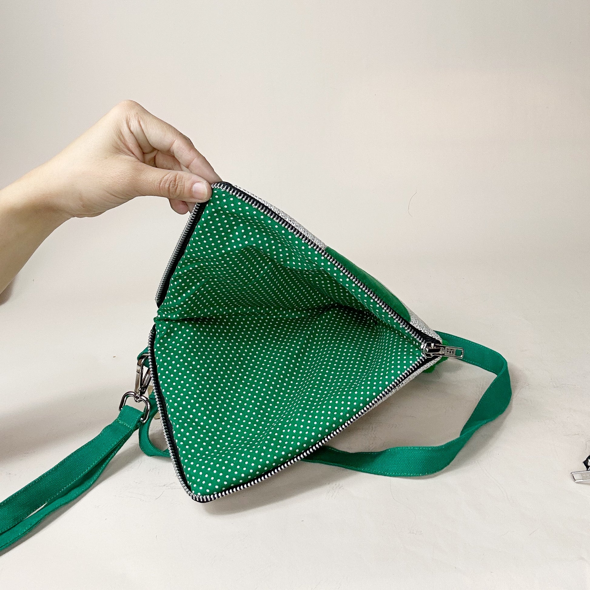 jute cockatoo crossbody bag in green opened at the bottom