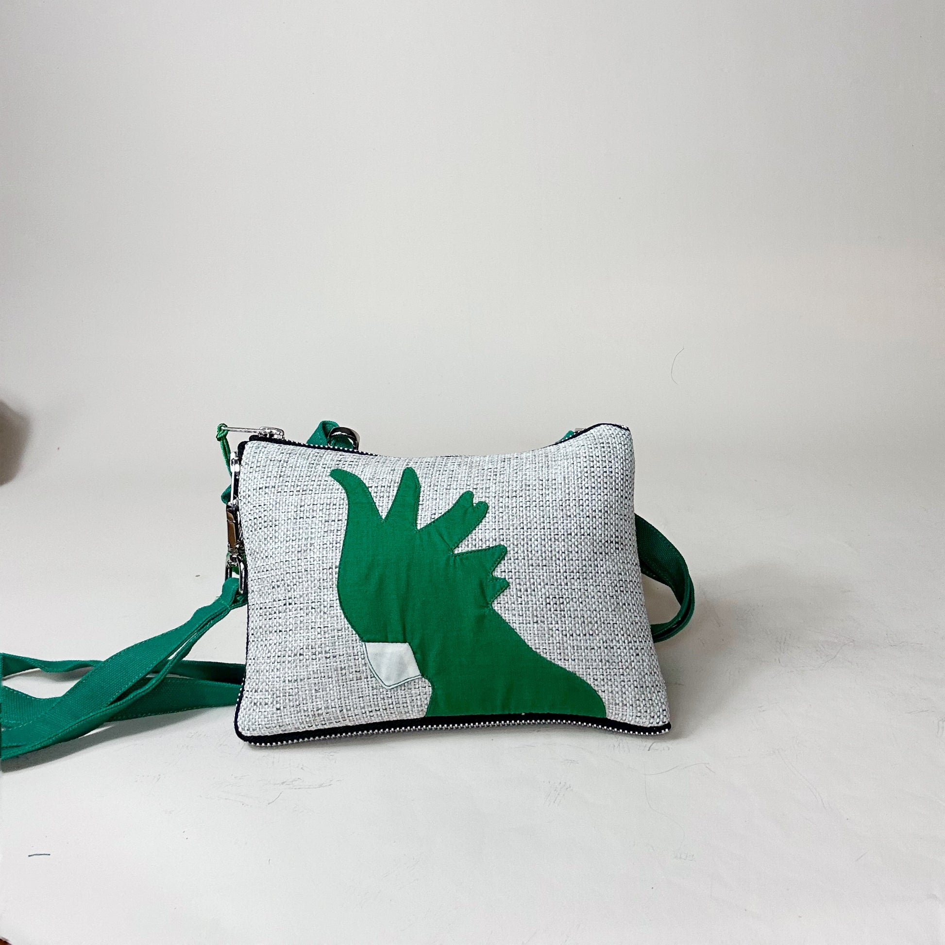 Green and gray pouch with a cockatoo design on a white background