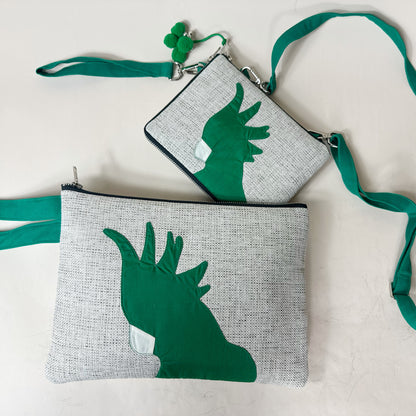Two gray pouches with green hand designs on a white background